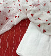 Red Kota Doria base with delicate white floral/vine embroidery and a white embroidered fabric.